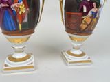two vases with pictures of people painted on them