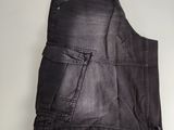 a close up of a pair of black denim shorts on a white surface