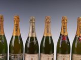 six bottles of champagne are lined up in a row on a table