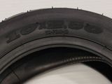 a close up of a tire on a white surface