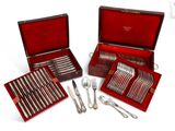 several silverware items in a red case on a white surface