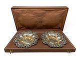 a pair of silver plated bowls in a leather case