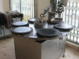 an image of a kitchen with a lot of pots and pans on the table