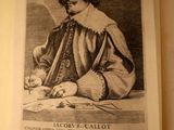an old book with a picture of a man sitting at a table