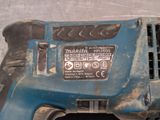 a close up of a corded drill on a table