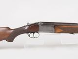a rifle with a wooden barrel and a wooden handle