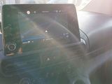 a car dashboard with a tablet in the center of it
