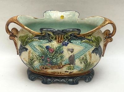 a vase that has a bird on it on a stand