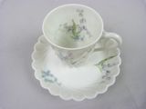 a cup and saucer on a plate on a table