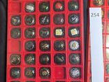 a red box filled with lots of buttons on a table