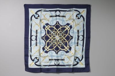 a blue and white square scarf with a design on it