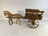 an old wooden horse drawn carriage with a wooden horse