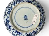 blue and white porcelain bowl with a blue flower design on it