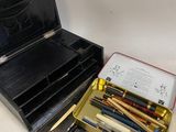 a box of pens and a box of pencils on a table