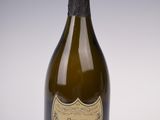 an old bottle of champagne on a white surface