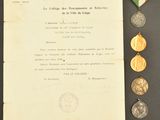 an old document with a medal, medal, and other items on a table