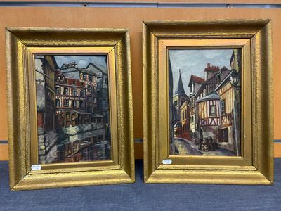 tableau représentant deux bâtiments dans un cadre doré sur un fond bleu