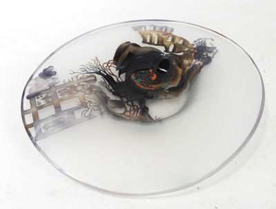 a glass plate with a skull on it on a table
