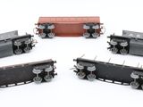 four different types of train cars on a white surface