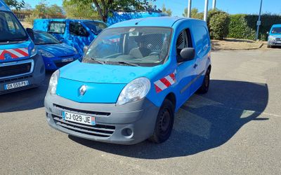 a small blue van that is parked in a parking lot