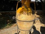 a large yellow vase that is sitting on a cart
