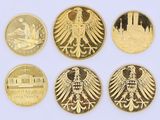 four different types of gold coins with eagle heads on them