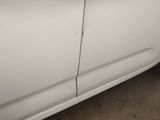 a white car that has been painted white and has a hole in the side