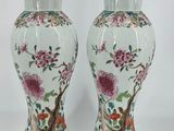 pair of chinese vases with flowers and birds painted on them