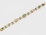 a gold and jade bracelet