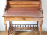 a wooden desk with a drawer underneath it on a hard wood floor