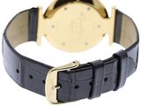 a gold and black watch with a black leather strap