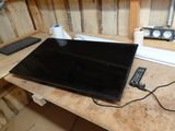 a laptop computer sitting on top of a wooden desk