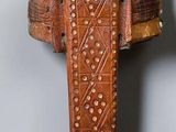 a picture of a metal and wood cross on a wall