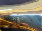 a close up of a brass instrument on a blue surface