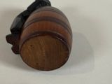 a small wooden barrel with a cell phone on top of it