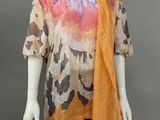 a mannequin mannequin wearing an orange scarf and black dress