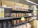 a shelf full of wine glasses and other items in a store