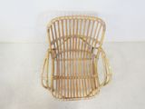 a wicker chair sitting in the corner of a room