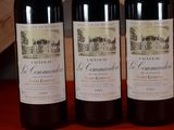 three bottles of wine sitting on top of a table next to each other