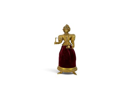 a gold statue of a woman holding a cup