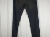 a pair of black jeans hanging on a white curtain