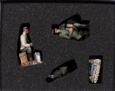 three figurines in a black box with a man on a motorcycle