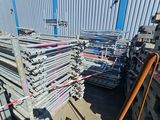 a large pile of steel pipes in a warehouse