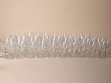 bottles and glasses are lined up on a shelf in a room