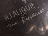 a close up of a black vase with writing on it