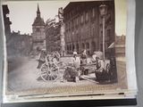 an old photo of a horse drawn carriage on a city street
