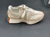 beige and white sneakers on display in a shoe store