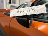 a sticker on the side mirror of an orange car