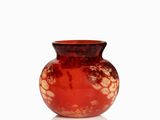 a red vase that is sitting on a white surface