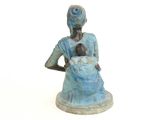 statue of a woman holding a baby in a blue dress